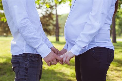 Premium Photo | Midsection of couple holding hands