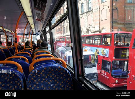 Back view people in bus interior top deck of transport for London tfl red public passenger ...