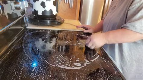 Cleaning glass top stove with razor blade - YouTube