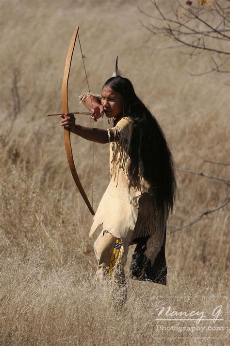 A young Native American Indian boy using or hunting with a bow and ...