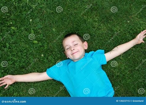 Kid lying on grass stock image. Image of green, grass - 13623715