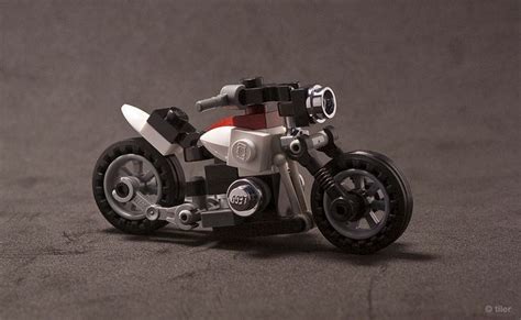 a lego motorcycle is sitting on the ground with its front wheel out and ...