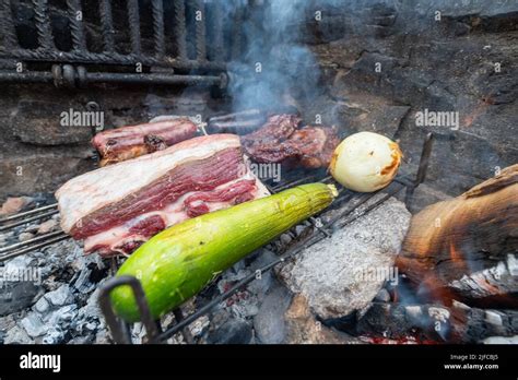 Typical Uruguayan and Argentine Asado Cooked on fire. Entrana and Vacio ...