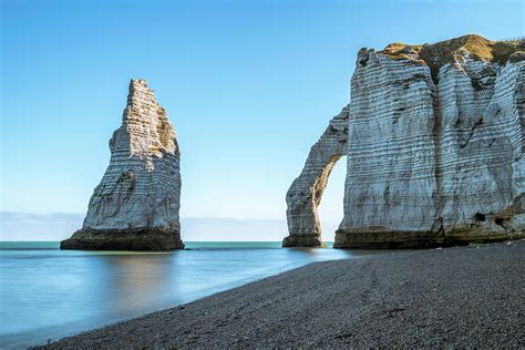 Chalk cliffs of Etretat with the natural arch Porte d'Aval and the stone needle called L ...