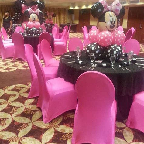 the tables are decorated with minnie mouse balloons