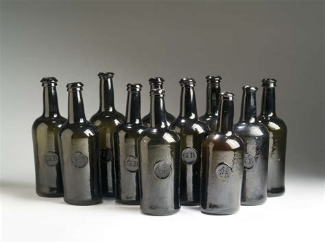 TWELVE ENGLISH 'BLACK GLASS' SEALED WINE BOTTLES, 1820-30.