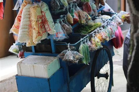 Premium Photo | A mobile vegetable seller with a cart that was stopped in the middle of the ...