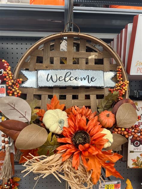 a welcome sign hanging from the side of a wooden basket filled with ...