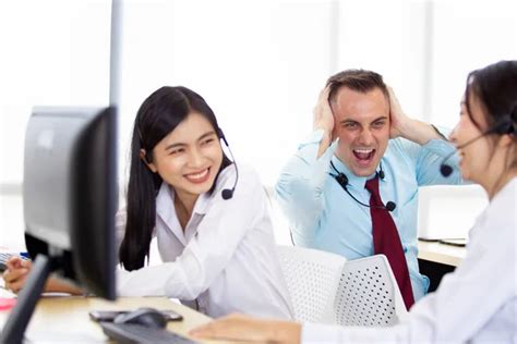 Harmful noisy environment in the workplace issue. A man screaming to his colleague who enjoy ...