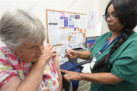 Patient receiving the 2023 Covid-19 vaccine - Stock Image - C058/6015 ...