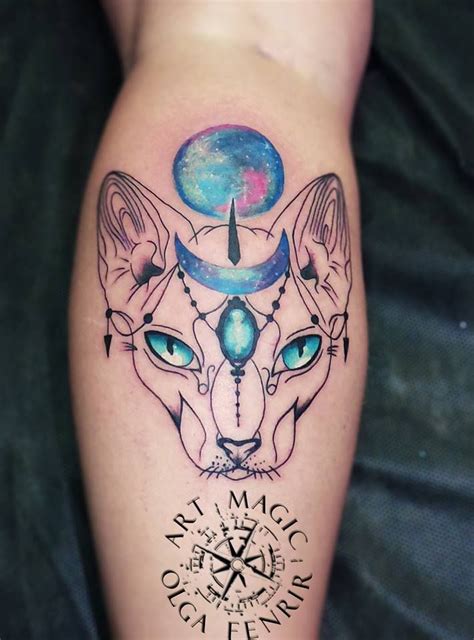 a tattoo on the leg of a person with blue eyes and a cat's head