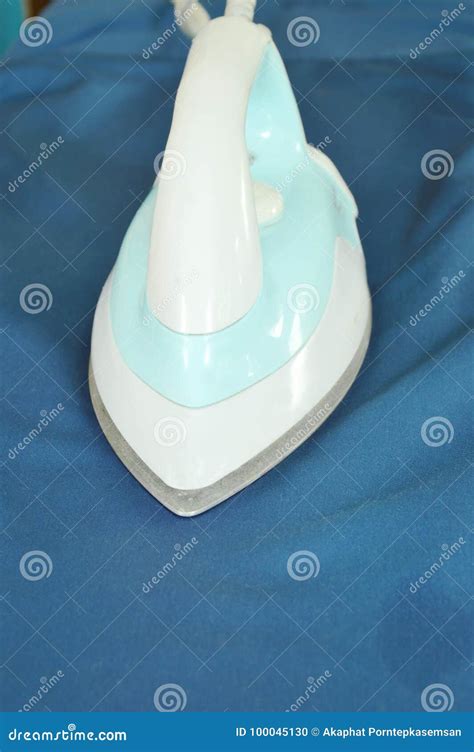 Automatic Electric Iron Pressing Cloth on Ironing Board Stock Photo ...