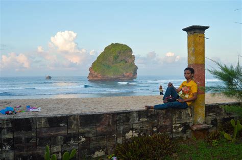 malang, indonesia, 2022 - Beach landscape with people leaning on the Chinese cave beach fence in ...