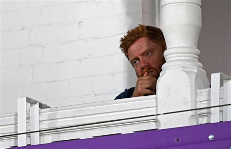 England's Jonny Bairstow watches from the pavilion after feeling ...