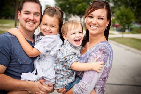 Happy Young Family Laughing Together Outside Stock Photo | Royalty-Free ...