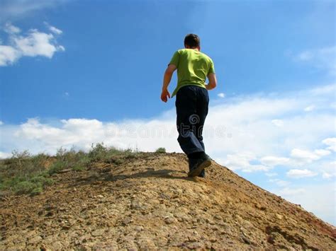 The Man Climbing Up the Hill Stock Image - Image of brown, blue: 21173411