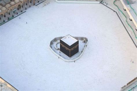 An aerial view shows an empty white-tiled area surrounding the Kaaba in Mecca's Grand Mosque, on ...