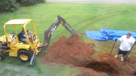 Backhoe digging up our yard - YouTube