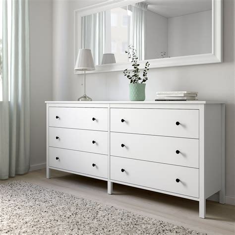 a white dresser and mirror in a room