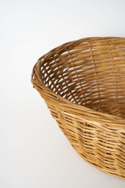 Premium Photo | Brown straw basket on a white surface