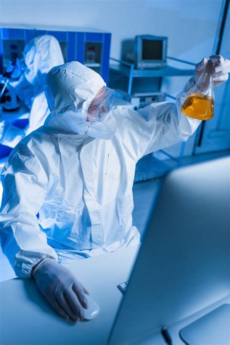 Scientist in Hazmat Suit Holding Flask Stock Image - Image of orange, laboratory: 244575335