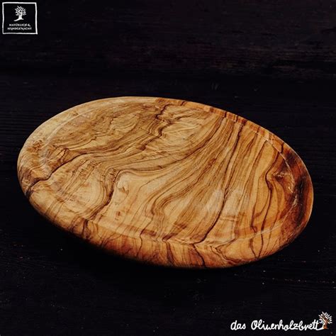 Round cutting board with juice groove out of olive wood, handmade