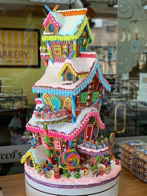 there is a large cake made to look like a gingerbread house with candy ...