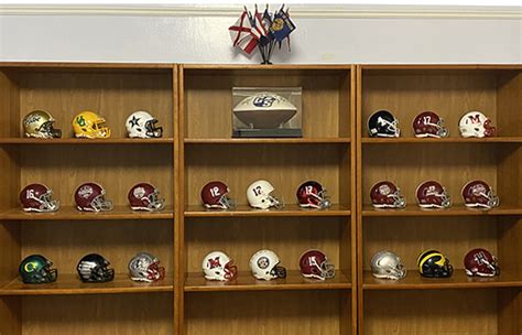 Zeb Baker's collection of miniature football helmets in his office ...