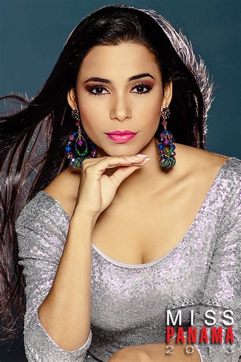 a woman with long hair and earrings posing for the camera