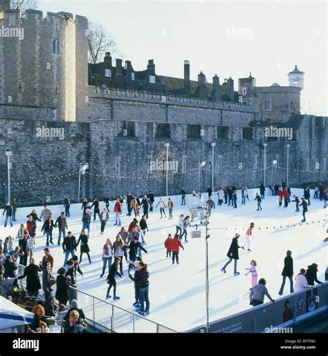 Ice skating at the outdoor Tower of London ice rink near Tower Bridge ...