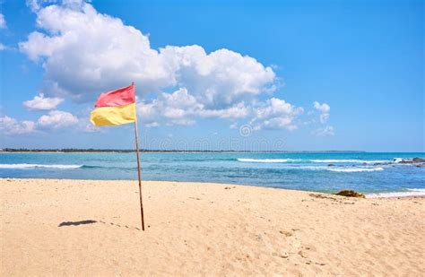 Tropical Beach with Red and Yellow Flag Stock Image - Image of exotic, paradise: 169205869