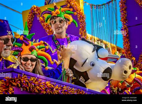 Mardi Gras revelers ride a Mardi Gras float during the Joe Cain Day Mardi Gras parade, Feb. 7 ...