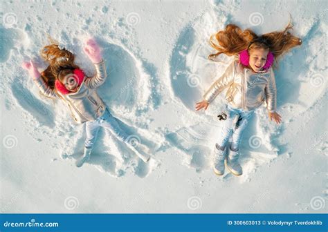 Snow Angels Made by a Kids in the Snow. Smiling Children Lying on Snow ...