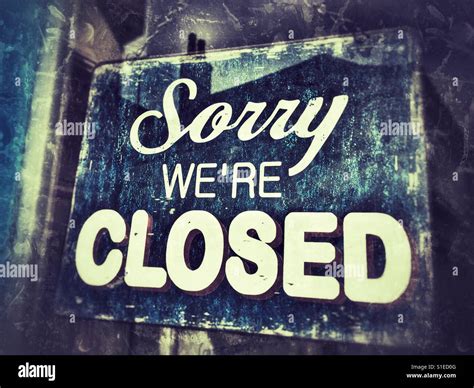 Sorry we're closed sign in shop door window Stock Photo - Alamy