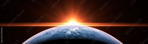 Sunrise over the planet Earth concept with a bright sun and flare and ...