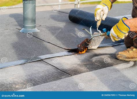 Man Heating and Melting Bitumen Roofing Flat Roof Installation Stock ...