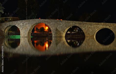 Old stone bridge and its reflection at night Stock Photo | Adobe Stock