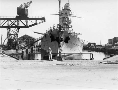 A sailor observes the listing French battleship Dunkerque in the Vauban ...