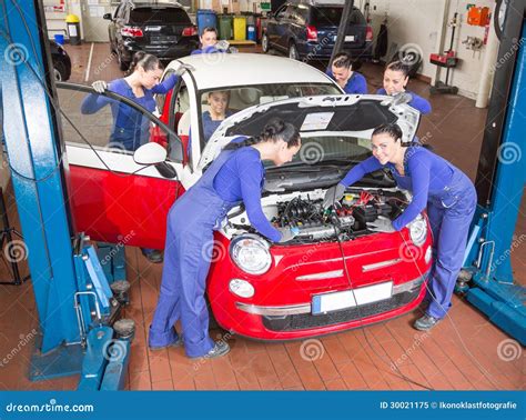 Multiple Auto Mechanics Repairing A Car In Garage Royalty Free Stock Photo - Image: 30021175