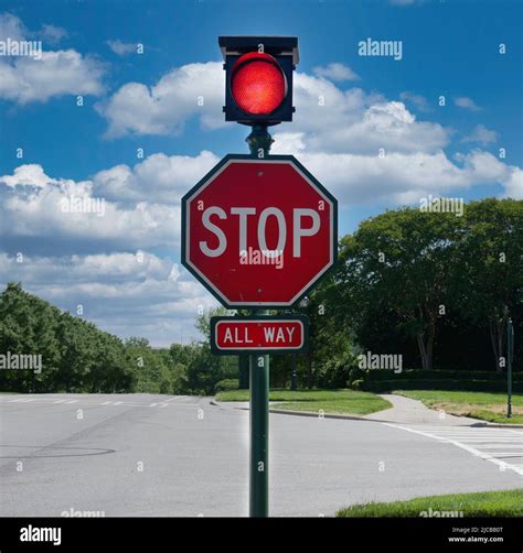 Stop sign with red traffic light Stock Photo - Alamy