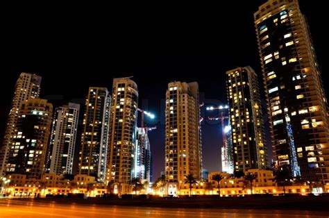 Colorful night view of city of Dubai with modern downtown buildings ...