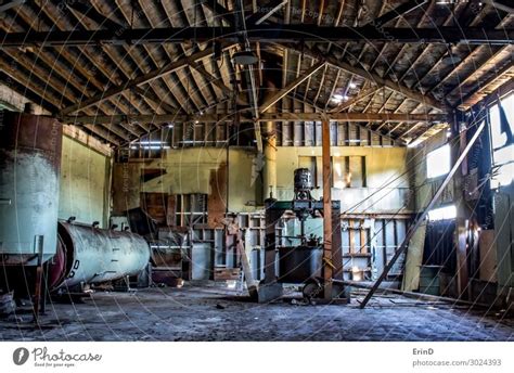 Abandoned Cannery Warehouse Interior with Rusty Machines - a Royalty Free Stock Photo from Photocase