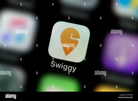 A close-up shot of the Swiggy app icon, as seen on the screen of a ...