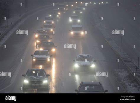 08 March 2023, Hesse, Gießen: Cars driving on the A485 in snowfall. An official warning of ...