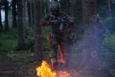 Soldier in Action at Night jumping over fire 31033494 Stock Photo at Vecteezy