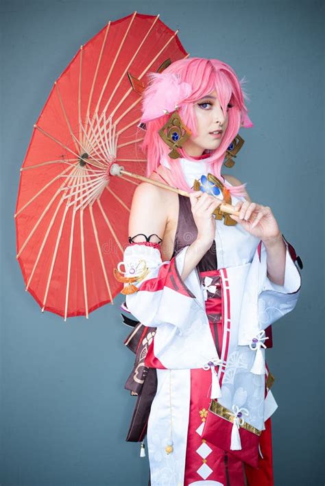 Female Cosplayer in a Pink Anime Costume Wearing Pink Hair Stock Image - Image of raises, hair ...