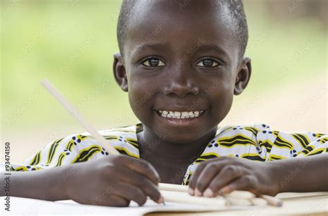 Black Boy Drawing and Writing in School. Little black African ethnicity ...