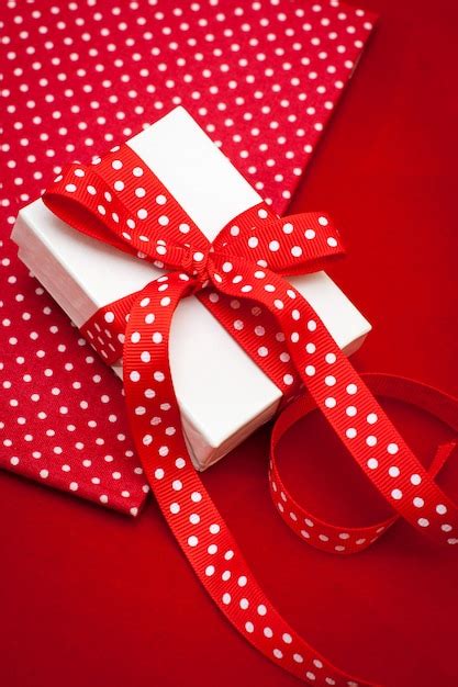 Premium Photo | White gift box with red ribbon