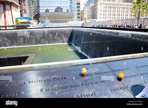 9/11 memorial at ground zero, waterfalls with names inscribed around ...