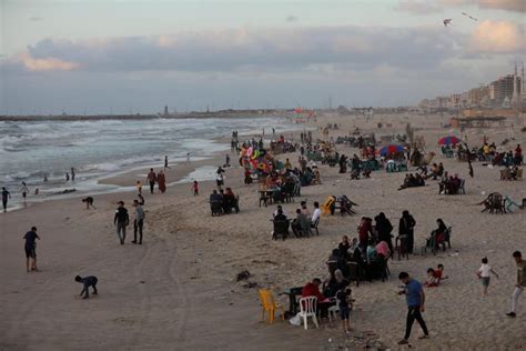 GAZA CITY, GAZA – MAY 22: Palestinians with their famlies enjoy the beach following cease-fire ...